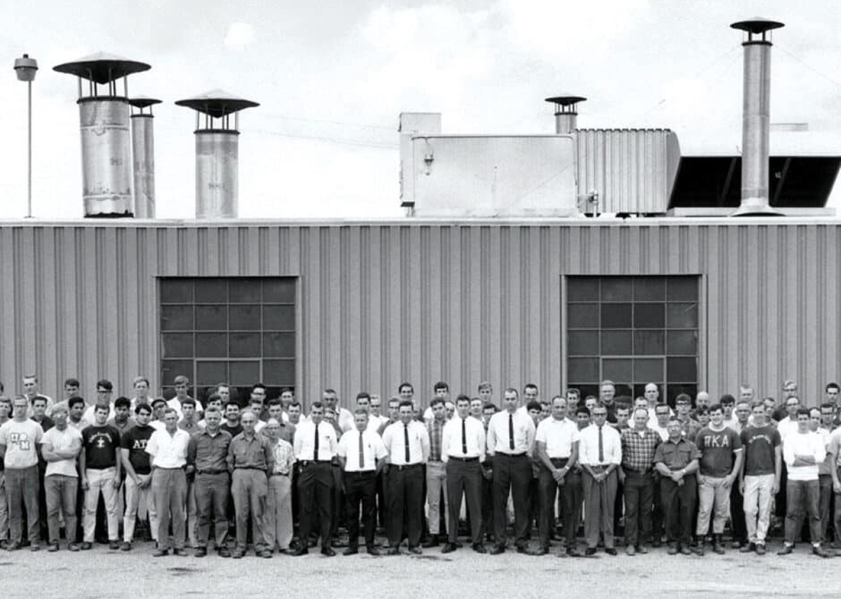 1970s staff photo outside plant