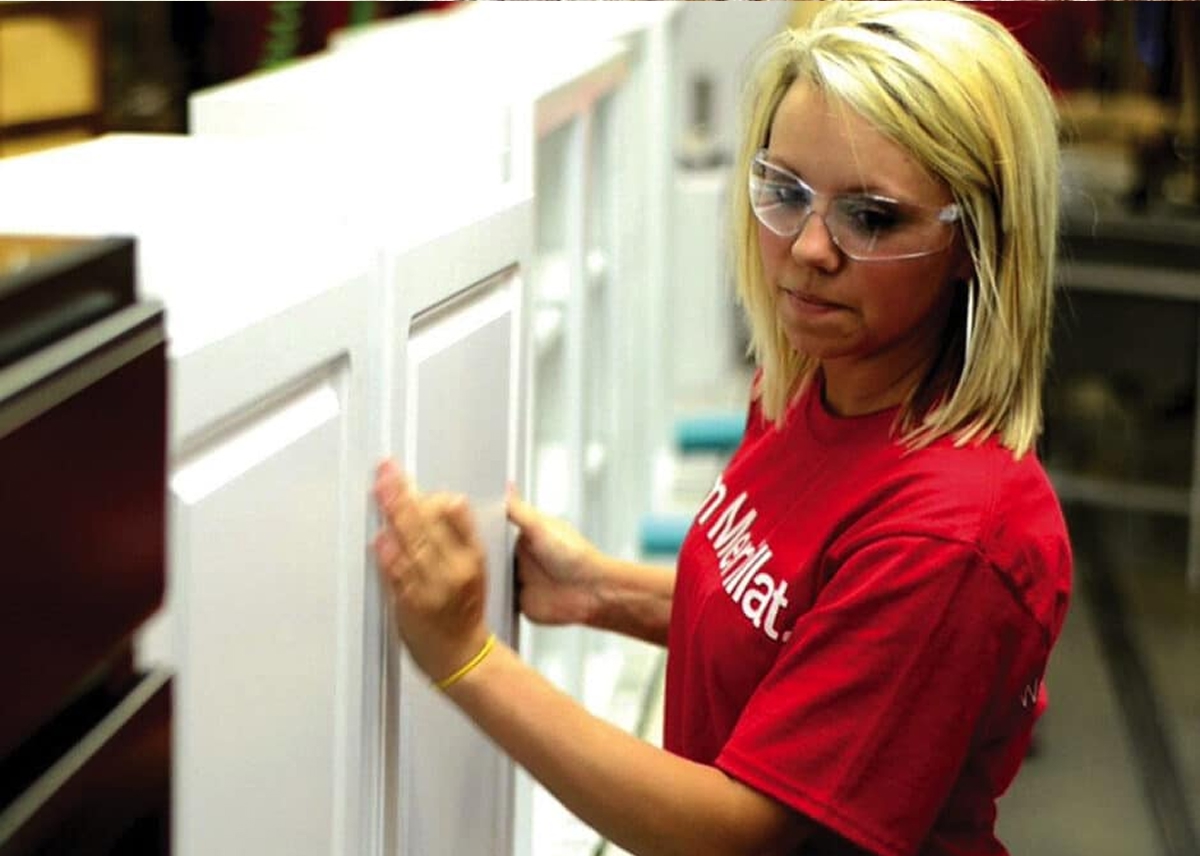 Woman adjusting cabinet